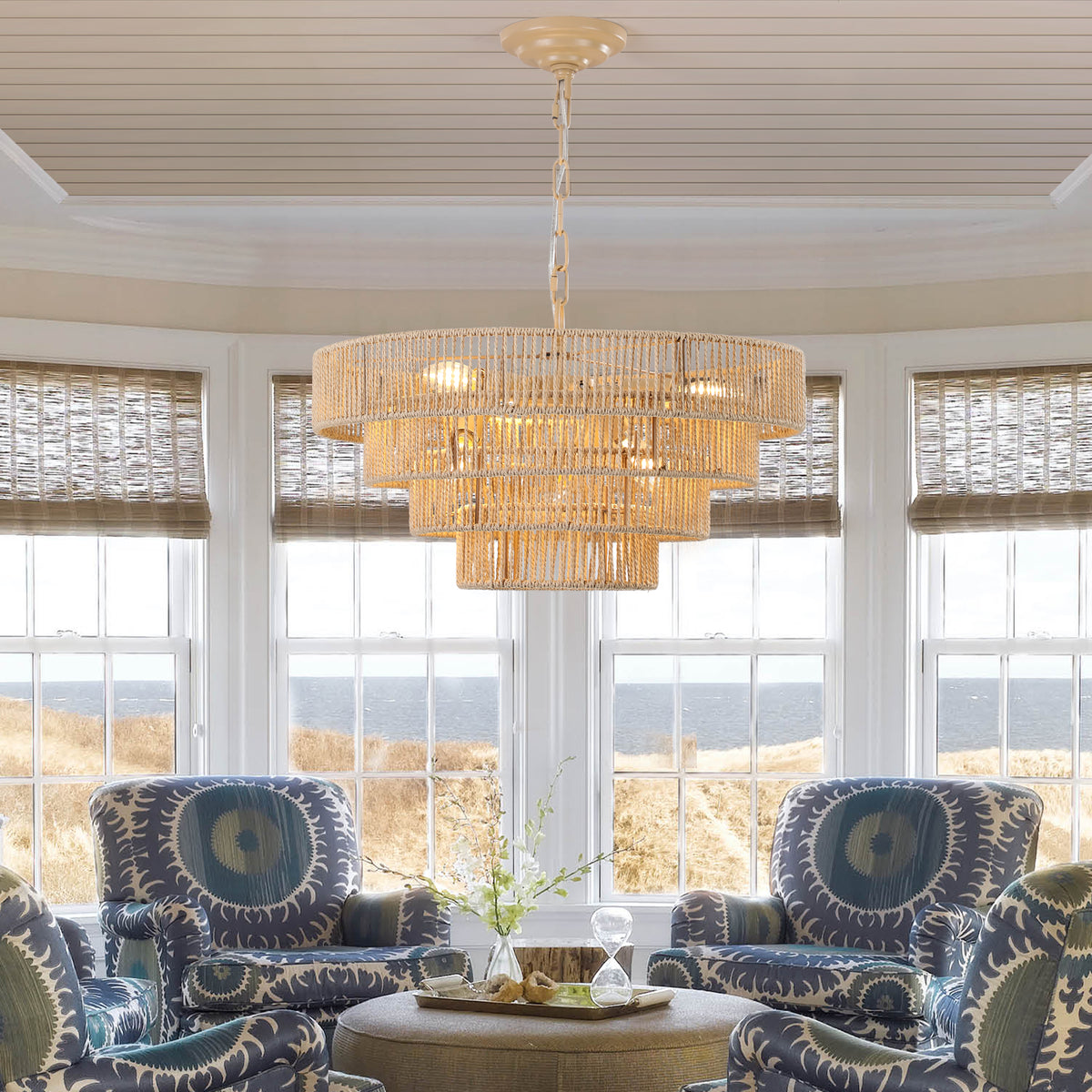 Modern woven hemp rope tiered chandelier hanging above a seating area near bay windows, elegant boho pendant light
