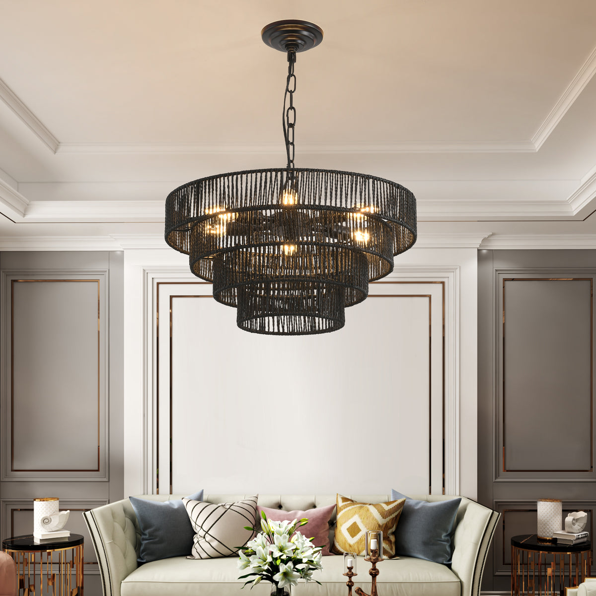 Black hemp rope tiered chandelier hanging in an elegant living room with paneled walls, boho ceiling light fixture