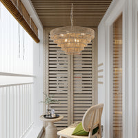 Woven hemp rope tiered chandelier hanging on a sunlit balcony with bamboo blinds, boho pendant light fixture