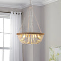 The Willow Beaded Chandelier suspended in a bright neutral-toned room near a large window, featuring a round natural wood-finished frame, layered white wooden bead strands forming a curved basket silhouette, exposed warm-glowing bulbs, and a chain-hung ceiling mount.