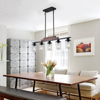 The Winslow Farmhouse Kitchen Island Chandelier hanging above a dining table in a farmhouse-style dining room