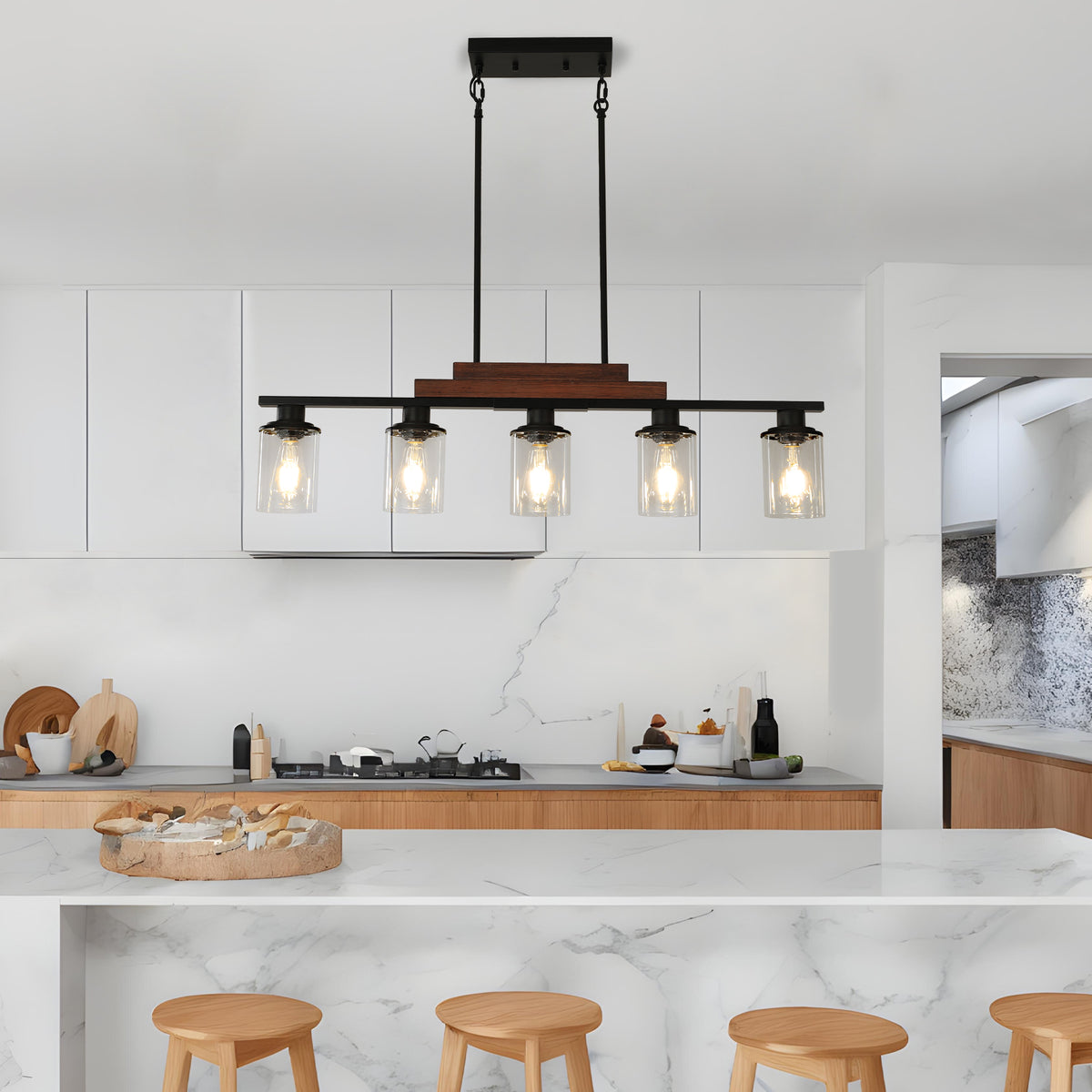 The Winslow Farmhouse Kitchen Island Chandelier above a kitchen island with five glass shades and a wood and black metal frame