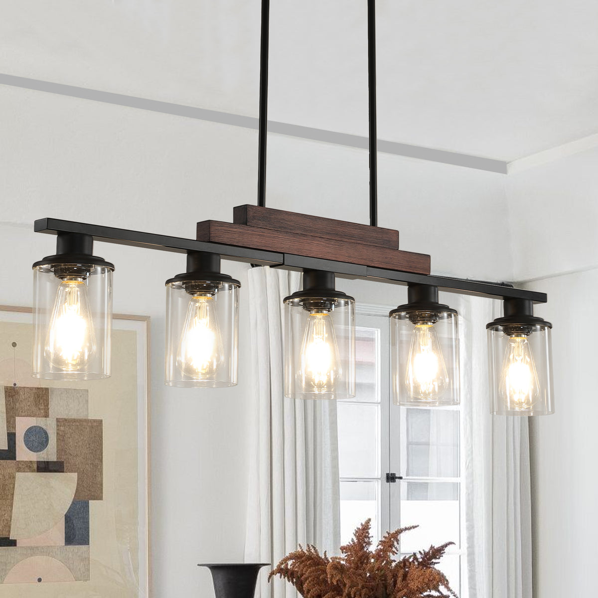 The Winslow Farmhouse Kitchen Island Chandelier featuring five clear glass shades, a wood accent, and black metal frame
